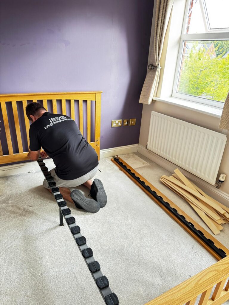 removal staff dissembling a king size bed ready to move